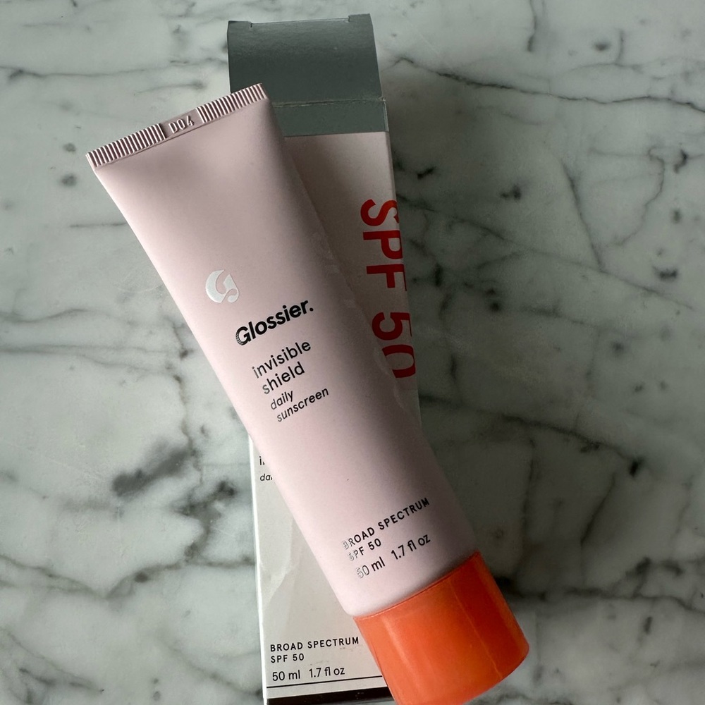 Glossier Invisible Shield SPF 50 Sunscreen - Pink and Orange